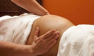 Pregnant woman having a massage at a spa day
